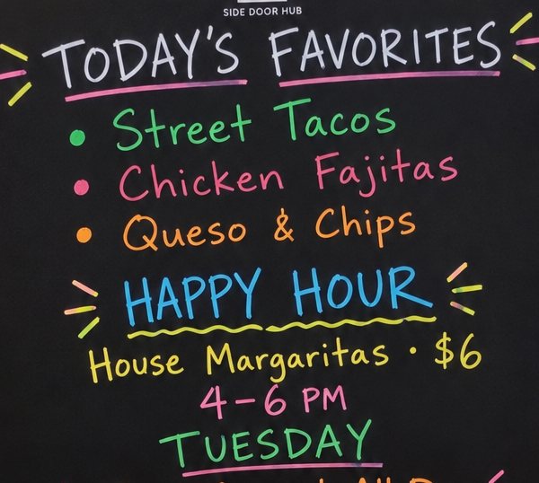 The writable area of a Side Door Hub board in a Tex-Mex restaurant: today’s favorites, happy hour and a Tuesday taco special.